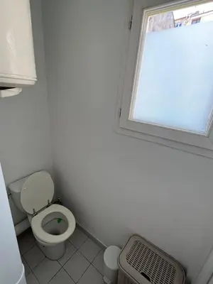 a bathroom with a toilet and a window at Appartement centre historique Ajaccio in Ajaccio