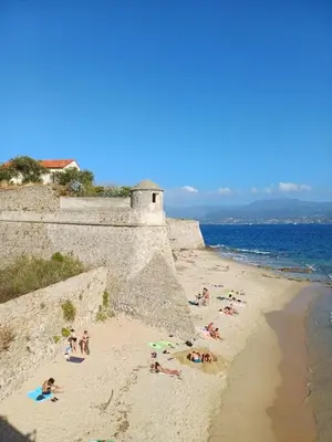 a group of people on a beach near the ocean at Appartement centre historique Ajaccio in Ajaccio
