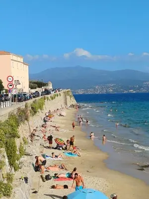 a group of people on a beach near the ocean at Appartement centre historique Ajaccio in Ajaccio