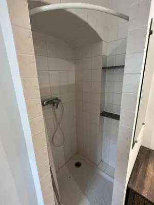 a shower in a bathroom with white tiles at Appartement centre historique Ajaccio in Ajaccio