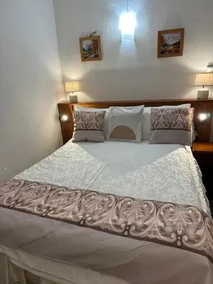 a bedroom with a large bed with white sheets and pillows at Casa Bella Centre de Corsica in Corte