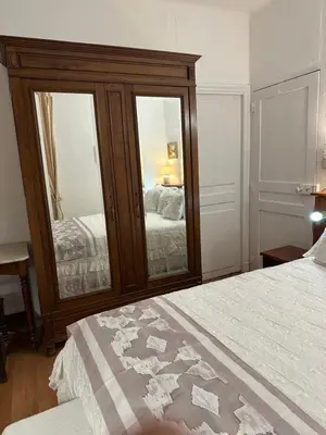 a bedroom with a large mirror and a bed at Casa Bella Centre de Corsica in Corte