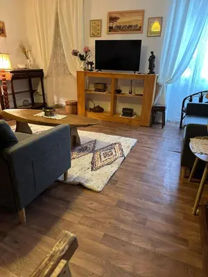 a living room with a couch and a television at Casa Bella Centre de Corsica in Corte