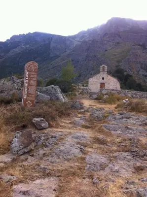 a sign on the side of a mountain with a building at Casa Bella Centre de Corsica in Corte