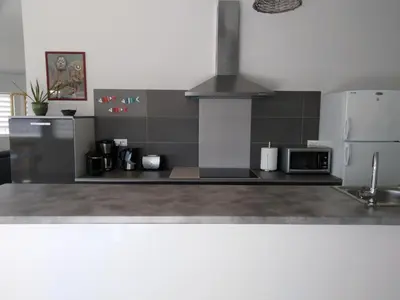 a kitchen with a stove and a refrigerator at Le Golfe in Figari