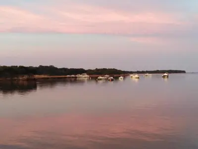 a group of boats on the water at sunset at Le Golfe in Figari