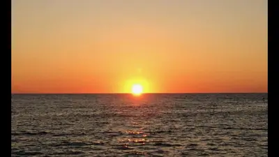 an orange sunset over the ocean at Rez de villa, tout confort 4 pers parking Proche Ajaccio in Alata