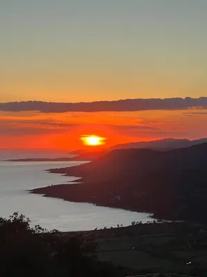 a sunset over a body of water with at Casa Campana in Viggianello