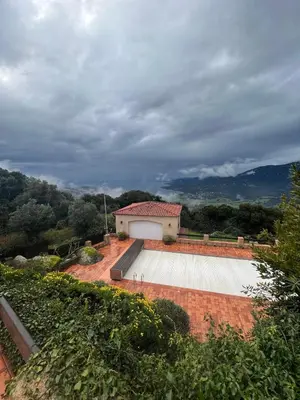 a house with a white garage and a building at Casa Campana in Viggianello