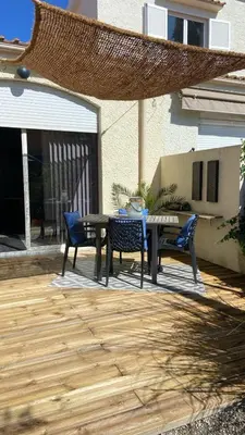 a patio with a table and chairs on a patio at Cozy cocoon 300m de la plage in Borgo