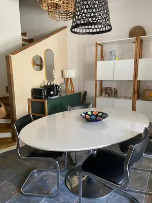 a dining room with a white table and chairs at Cozy cocoon 300m de la plage in Borgo