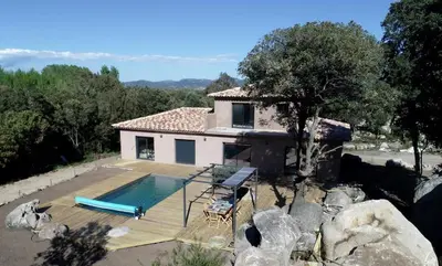 a house with a swimming pool in front of it at Villa avec Piscine in Pianottoli-Caldarello