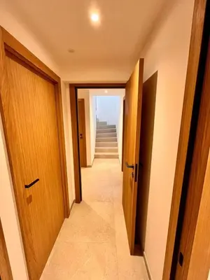a hallway with two doors and a stairway at Villa neuve d'exception 6ch SPA Piscine in Conca