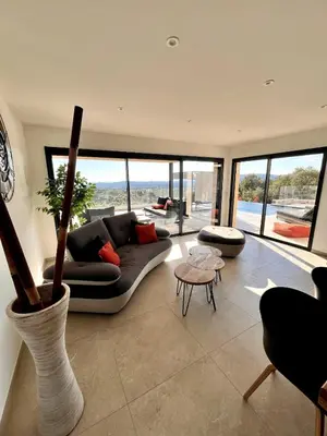 a living room with a couch and a table at Villa neuve d'exception 6ch SPA Piscine in Conca