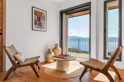 a living room with two chairs and a chess board at Magnifique villa 6 chambres avec piscine,Olmeto plage in Olmeto