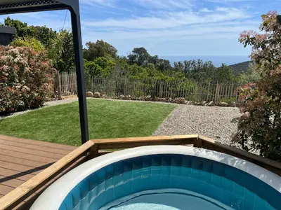 a backyard with a plunge pool and a wooden deck at Charmant appartement en Rez-de-chaussée de VILLA - Classification 3 étoiles in Sari Solenzara