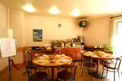 a restaurant with two tables and chairs with food on them at Hotel le Dauphin in Ajaccio