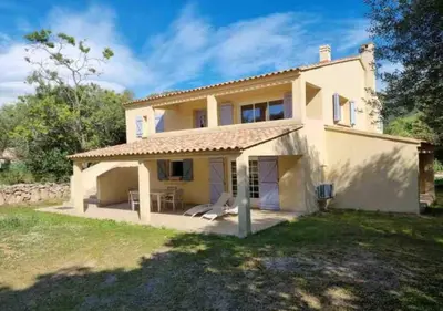 a large white house with a yard at A Filetta, Maquis & mer, dans un hameau de charme in Sartène