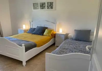 a bedroom with two beds and two night stands at A Filetta, Maquis & mer, dans un hameau de charme in Sartène