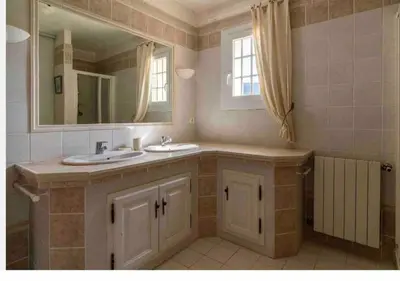 a bathroom with two sinks and a mirror at A Filetta, Maquis & mer, dans un hameau de charme in Sartène