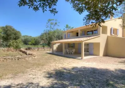 a house with a large yard in front of it at A Filetta, Maquis & mer, dans un hameau de charme in Sartène