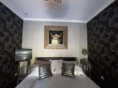 a bedroom with a bed with a picture on the wall at E Case Di Pietralba in Ajaccio