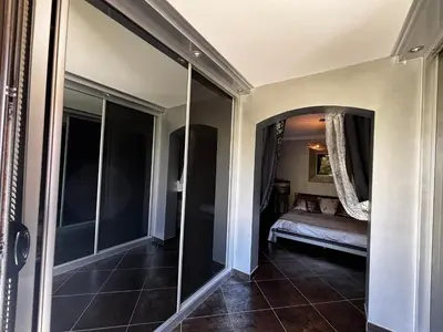 a hallway with a mirror and a bed in a room at E Case Di Pietralba in Ajaccio