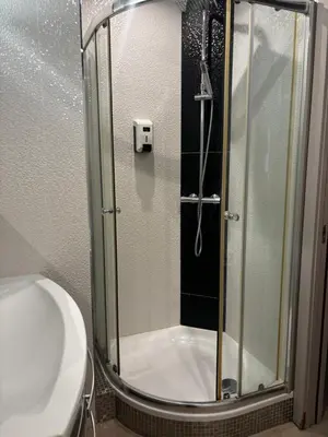 a shower with a glass door in a bathroom at E Case Di Pietralba in Ajaccio