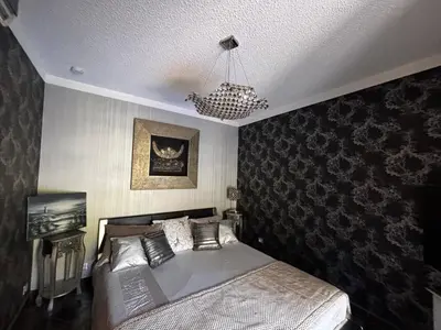 a bedroom with a bed and a chandelier at E Case Di Pietralba in Ajaccio