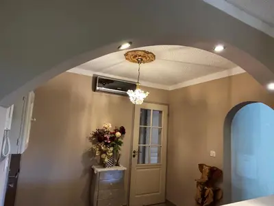 a room with a ceiling with a chandelier and a door at E Case Di Pietralba in Ajaccio