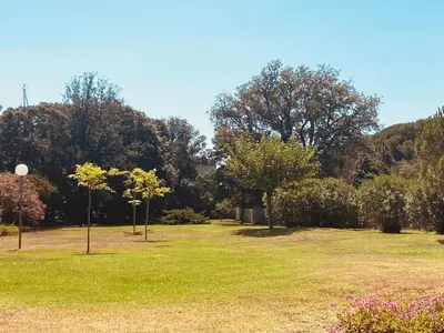 a park with trees and green grass and flowers at Maison en corse in Santa-Maria-Poggio