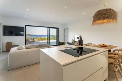 a kitchen and living room with a couch and a table at Villa Margaux with private pool & sea view in Conca