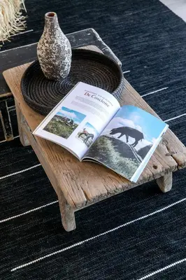 a wooden table with a book and a vase on it at Villa Margaux with private pool & sea view in Conca