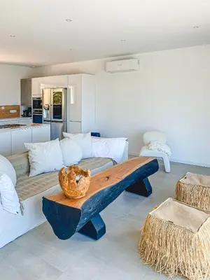 a living room with a couch and a table at Villa Margaux with private pool & sea view in Conca