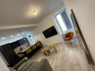 a living room with a couch and a television at Appartement cosy centre ville in Ajaccio