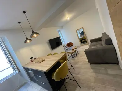 a living room with a couch and a table at Appartement cosy centre ville in Ajaccio