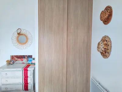 a bedroom with a wooden cabinet and a white dresser at Logement T2 Villa Bavella Vista in Quenza
