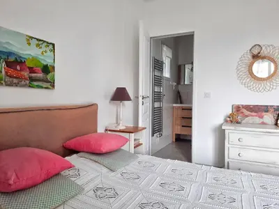 a bedroom with a bed with red pillows and a mirror at Logement T2 Villa Bavella Vista in Quenza