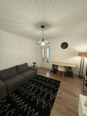 a living room with a couch and a table at Grand T2 Ajaccio - Proche port et transports in Ajaccio