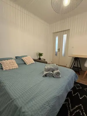 a bedroom with two beds with towels on them at Grand T2 Ajaccio - Proche port et transports in Ajaccio