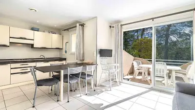 a kitchen and dining room with a table and chairs at Lisa Maria D N38 2P5 in Sari Solenzara