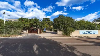 an empty street with a sign that reads kiss market at Lisa Maria D N38 2P5 in Sari Solenzara