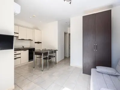 a kitchen and living room with a table and chairs at Lisa Maria E N60 3P7 in Sari Solenzara
