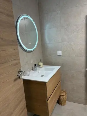 a bathroom with a sink and a mirror at T3 tout confort in Alata