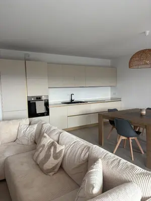 a living room with a couch and a table at T3 tout confort in Alata