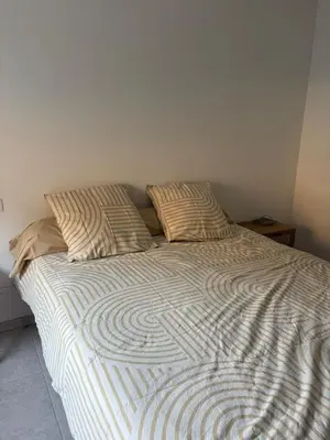 a bed with two pillows on it in a bedroom at T3 tout confort in Alata