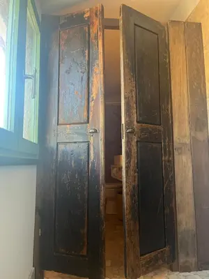 an open wooden door in a room with a window at Casetta Teppe rosse in Aléria