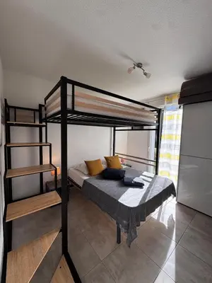 a bedroom with two bunk beds in a room at Mini-villa with swimming pool in Bonifacio residence in Bonifacio