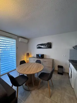 a kitchen with a table and chairs in a room at Mini-villa with swimming pool in Bonifacio residence in Bonifacio