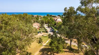 an aerial view of a house with the ocean in the background at A nostra casetta corsa,Tania, en bord de mer in Ghisonaccia
